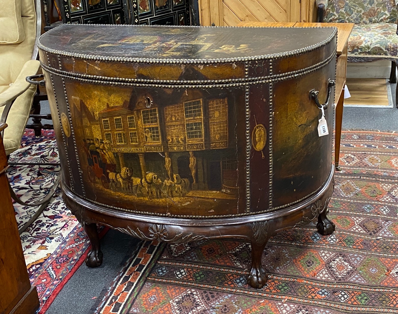 A late 19th / early 20th century studded painted leather d-shaped trunk, painted with tavern and interior scenes, on mahogany stand with carved claw and ball feet, width 112cm depth 54cm height 88cm